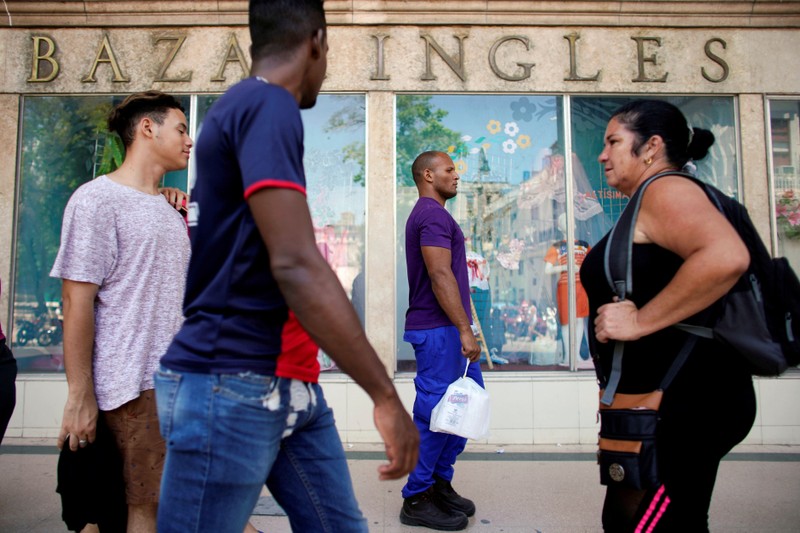 FILE PHOTO: People walk in a shopping zone in downtown Havana