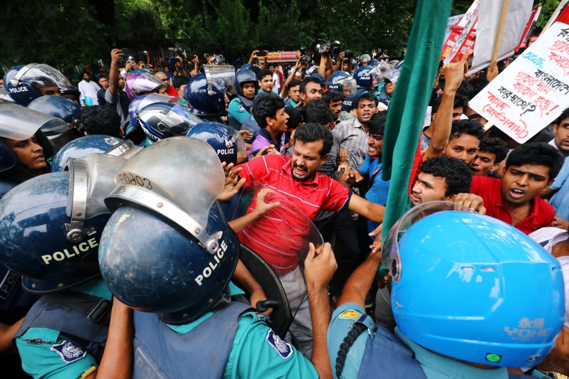 People clash with police near the Ministry of Power Energy and Mineral Resources as they protest against the increase in natural gas price in Dhaka