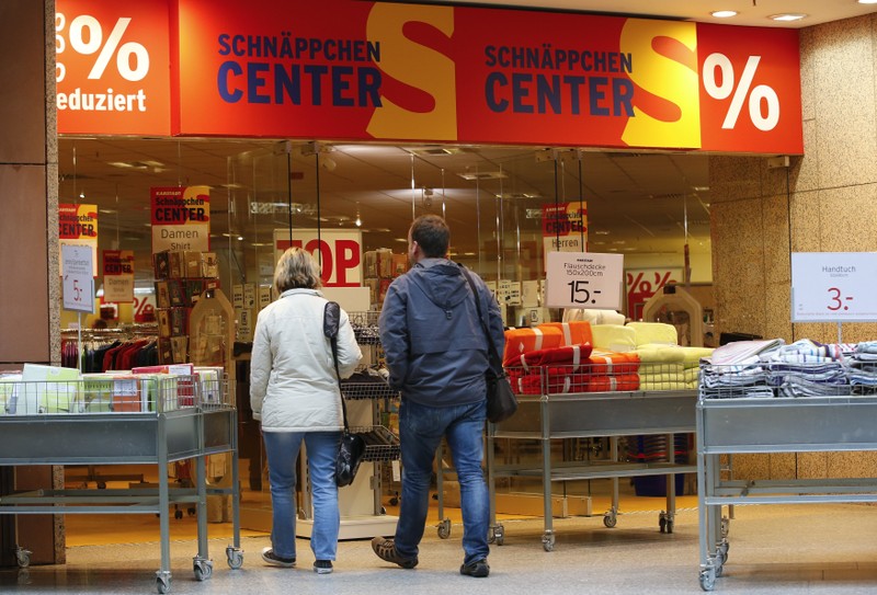 FILE PHOTO: Shoppers walk in a Karstadt hot deal department store in in Frankfurt/Oder