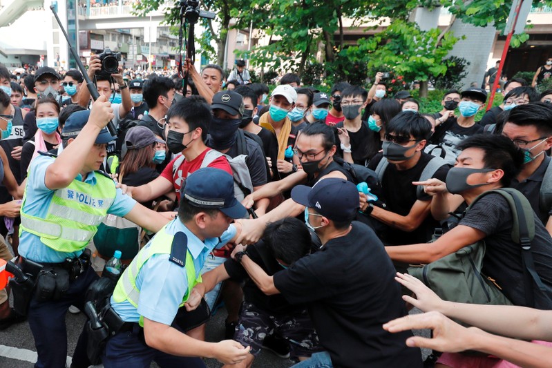 Police try to disperse pro-democracy activists after a march at Sheung Shui in Hong Kong
