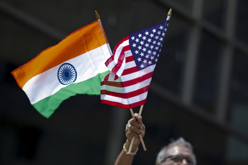 FILE PHOTO: Man holds flags of India and the U.S. during the 35th India Day Parade in New York