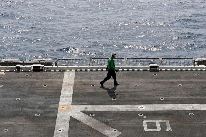 FILE PHOTO: A U.S. sailor walks on the flight deck of USS Boxer (LHD-4) in the Arabian Sea off Oman