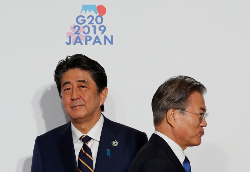 South Korean President Moon Jae-In is welcomed by Japanese Prime Minister Shinzo Abe upon his arrival for a welcome and family photo session at G20 leaders summit in Osak