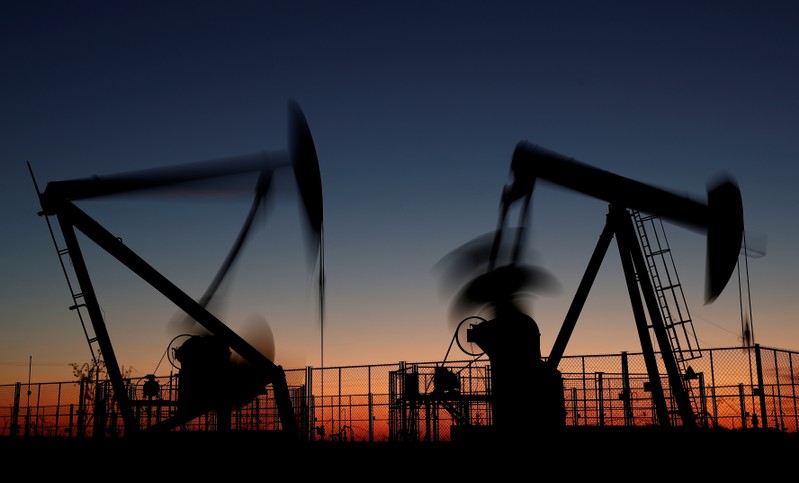 Oil pumps are seen after sunset outside Vaudoy-en-Brie