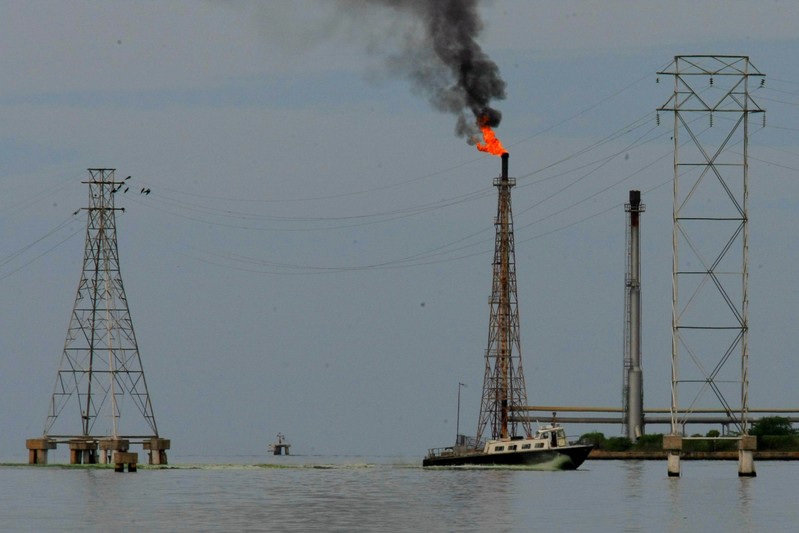 A boat is seen close to oil installations at Lake Maracaibo in Cabimas