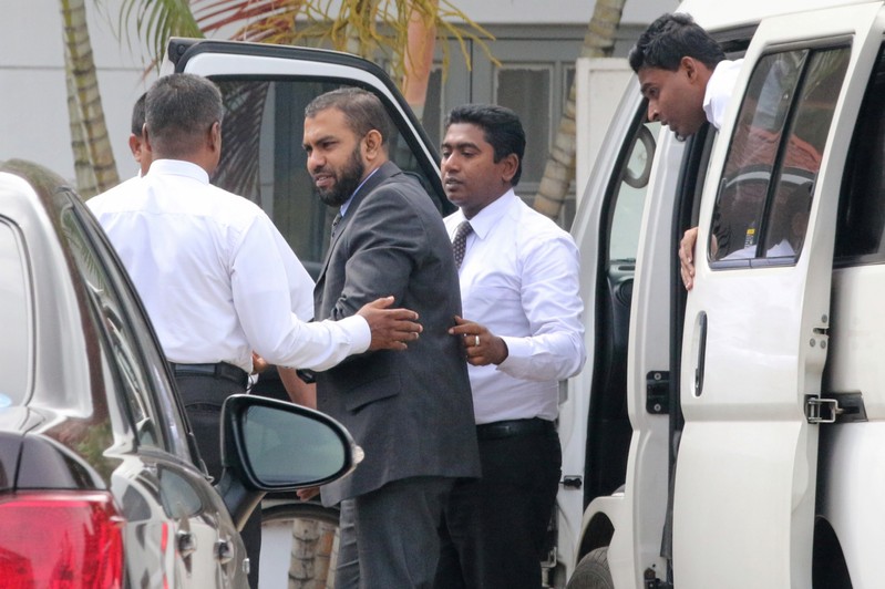 Muslim doctor Segu Shihabdeen Mohamed Shafi is escorted by Criminal Investigation Department officials at the Magistrate Court in Kurunegala