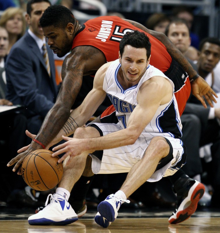 Magic guard Turkoglu is fouled by Raptors forward Johnson in NBA action in Orlando