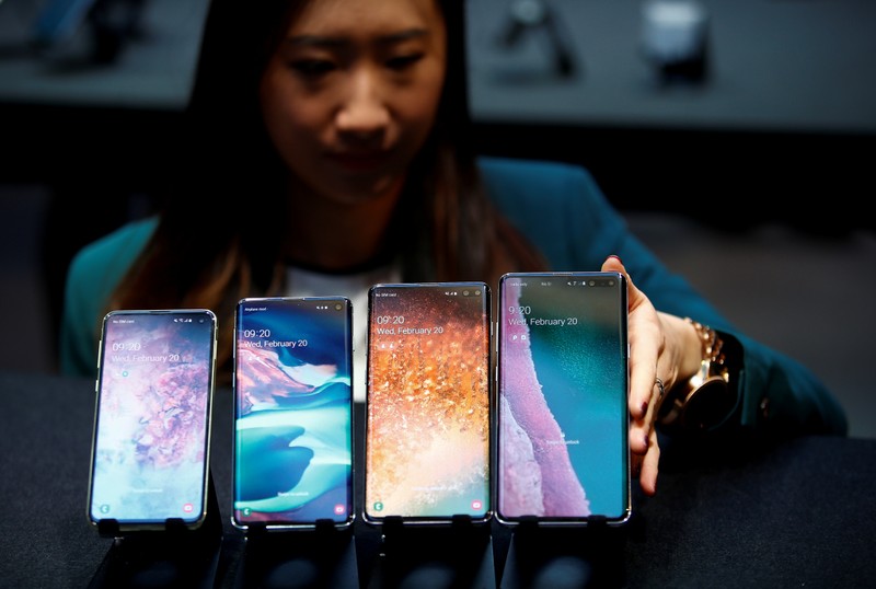 FILE PHOTO: A Samsung employee arranges the new Samsung Galaxy S10e, S10, S10+ and the Samsung Galaxy S10 5G smartphones at a press event in London