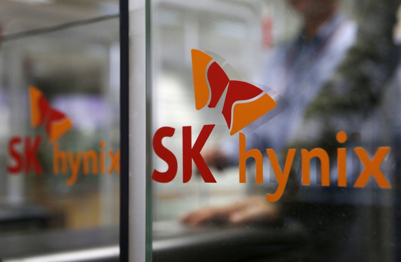 FILE PHOTO: Employee walks past the logo of SK Hynix at its headquarters in Seongnam