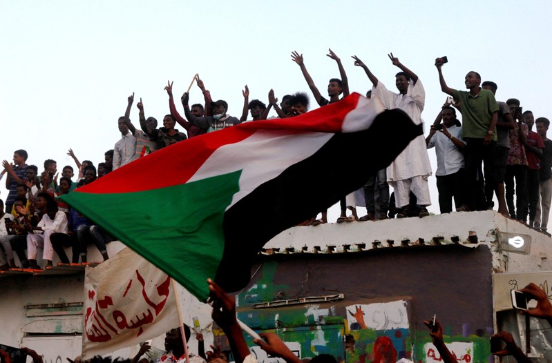 FILE PHOTO: Sudanese people celebrate on the streets of Khartoum