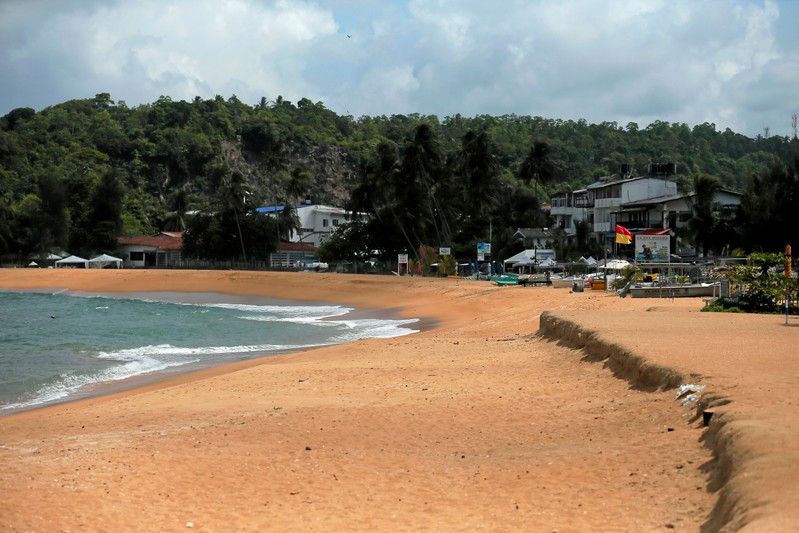 An empty beach is seen near hotels at Unawatuna beach in Galle