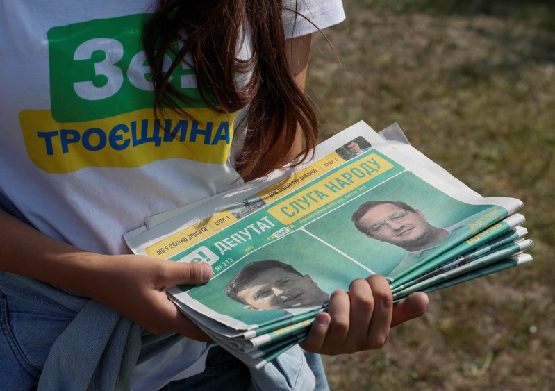 A volunteer holds electoral materials in support of the Servant of the People party ahead of Ukraine's parliamentary election in Kiev