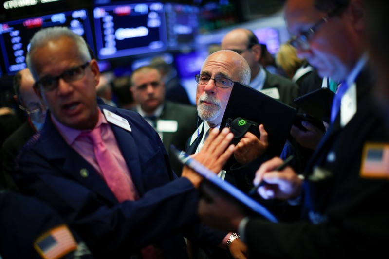 Traders work on the floor at the New York Stock Exchange (NYSE) in New York