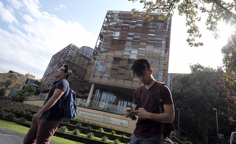 FILE PHOTO - University students walk outside the School of Business Building at the University of Sydney in Australia