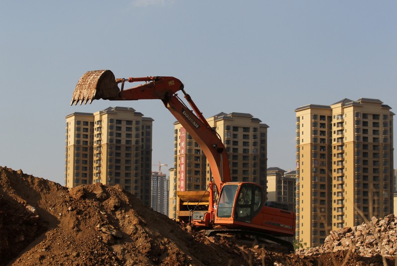 FILE PHOTO - An excavator works at a construction site in Chenggong District of Kunming