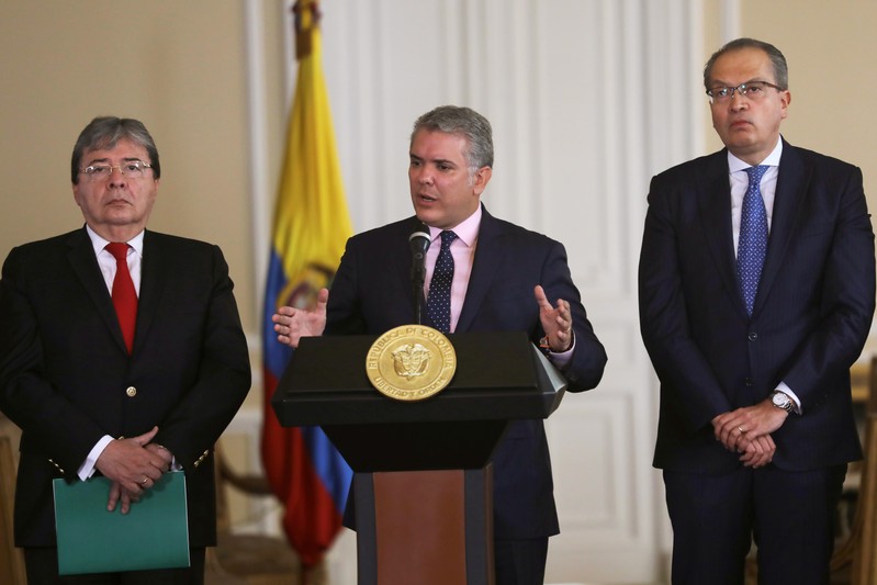 Colombia's President Ivan Duque speaks during a news conference, next to Colombia's Foreign Minister Carlos Holmes Trujillo and Colombian Inspector General Fernando Carrillo at the Presidential Palace in Bogota