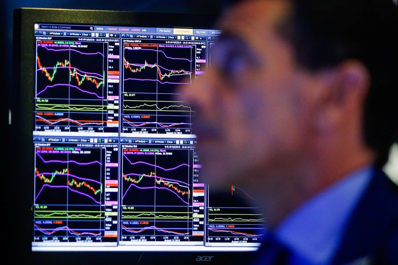 A trader looks at screens as he works on the floor at the New York Stock Exchange (NYSE) in New York