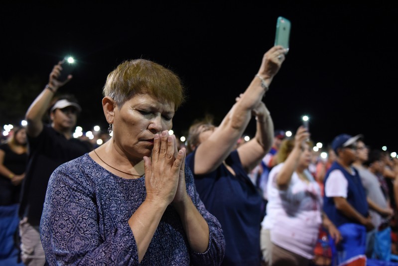 People gather for a vigil a day after a mass shooting in El Paso