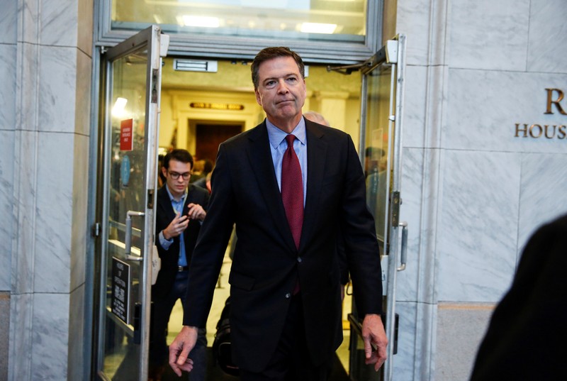 FILE PHOTO: Former FBI Director Comey departs after giving a private deposition to the House Judiciary and House Government and Oversight committees on Capitol Hill in Washington