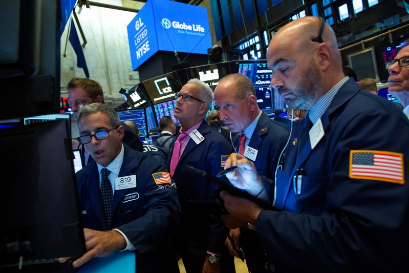 Traders work on the floor at the New York Stock Exchange (NYSE) in New York