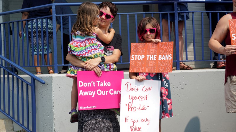 FILE PHOTO: Abortion rights advocates attend a rally after a judge granted a temporary restraining order on the closing of Missouri's sole remaining Planned Parenthood clinic in St. Louis