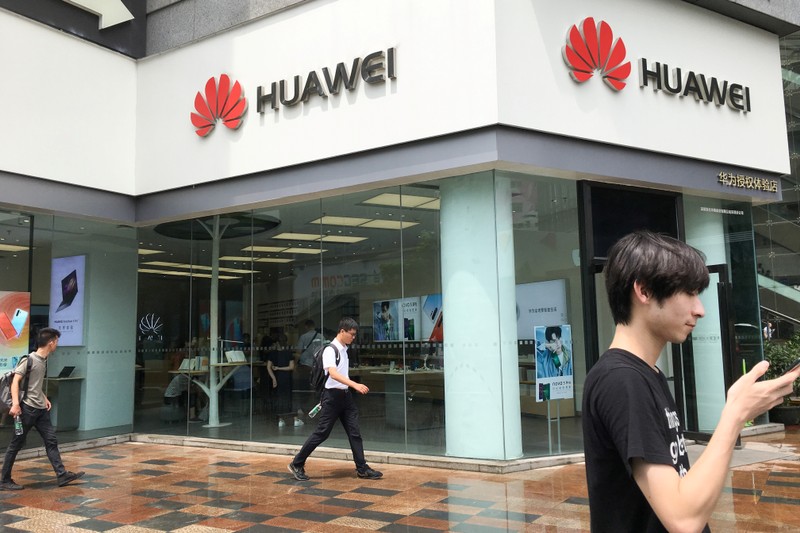 People walk past a Huawei store in Shenzhen