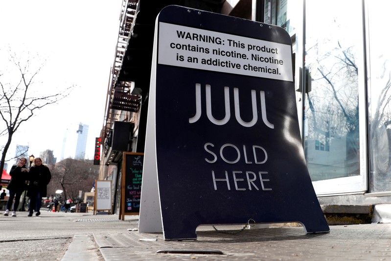 FILE PHOTO: A sign advertising Juul brand vaping products is seen outside a shop in Manhattan in New York City