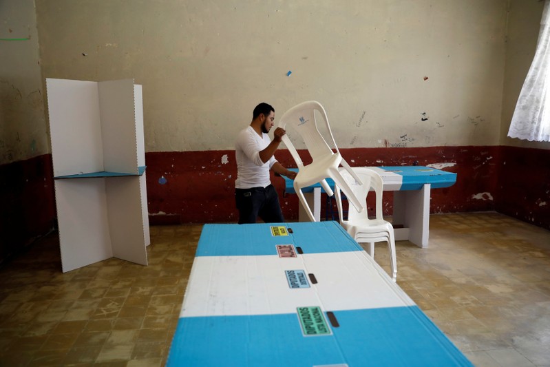 A Staff member of Guatemala's Supreme Electoral Tribunal (TSE) sets up voting equipment ahead of the second round run-off vote, in Guatemala City