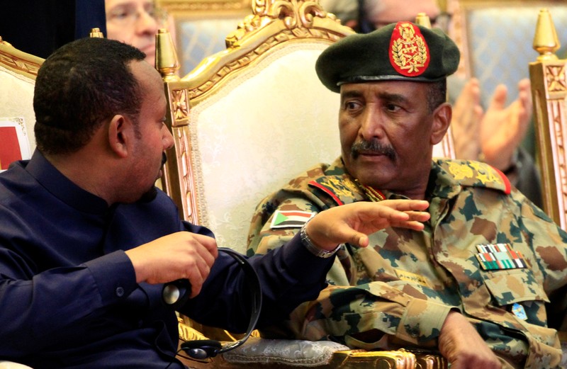 Sudan's Head Of Transitional Military Council, Lieutenant General Abdel Fattah Al-Burhan, listens to Ethiopia's Prime Minister Abiy Ahmed during the signing of the power sharing deal, in Khartoum
