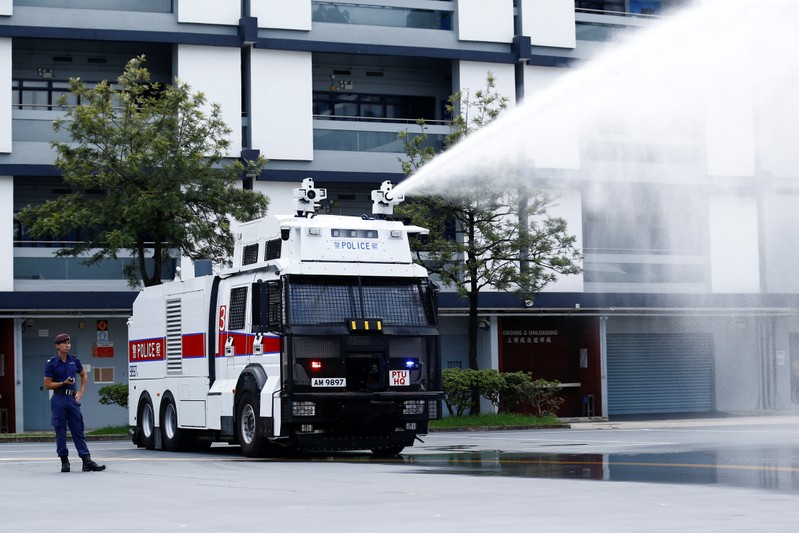 Police demonstrate a water cannon equipped vehicle at the compound of the Police Tactical Unit in Hong Kong