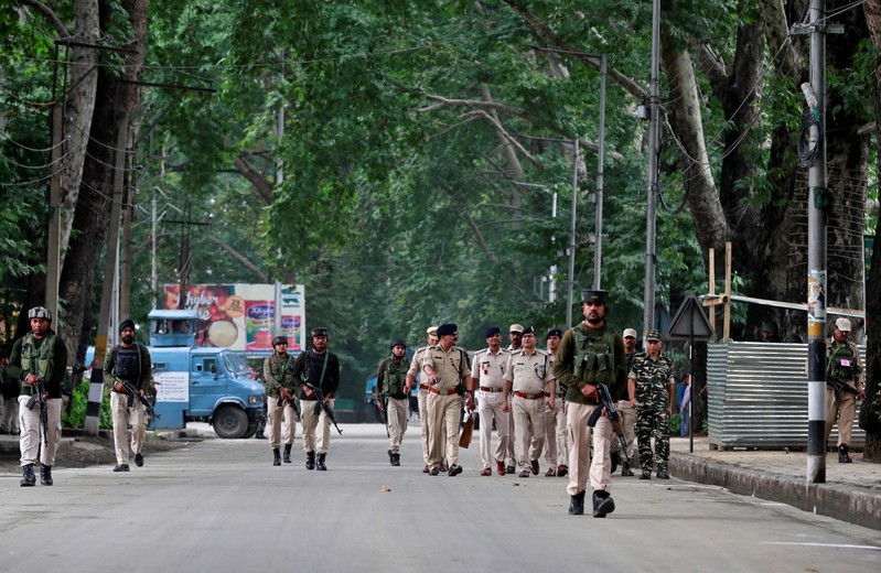Indian security force personnel patrol a road during restrictions after the government scrapped the special constitutional status for Kashmir, in Srinagar