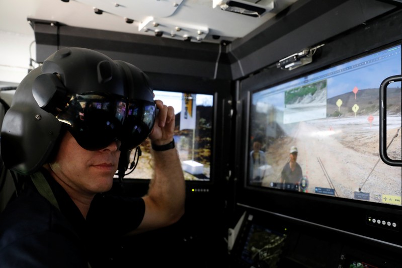 An exhibitor shows the operating suite of an Israeli armoured vehicle during a display of future systems at Elyakim Military Base in northern Israel