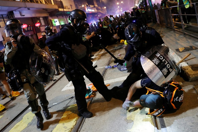 Riot police detains a demonstrator during a protest against police violence in Hong Kong