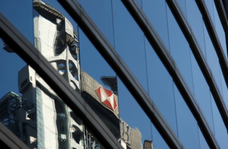 FILE PHOTO: The HSBC headquarters is reflected on the facade of a commercial building in Hong Kong