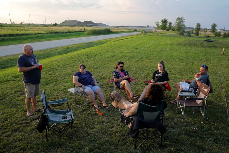 Jim and Kim Mahoney sits in their yard friends as the construction of the Foxconn manufacturing complex is seen in Mt. Pleasant