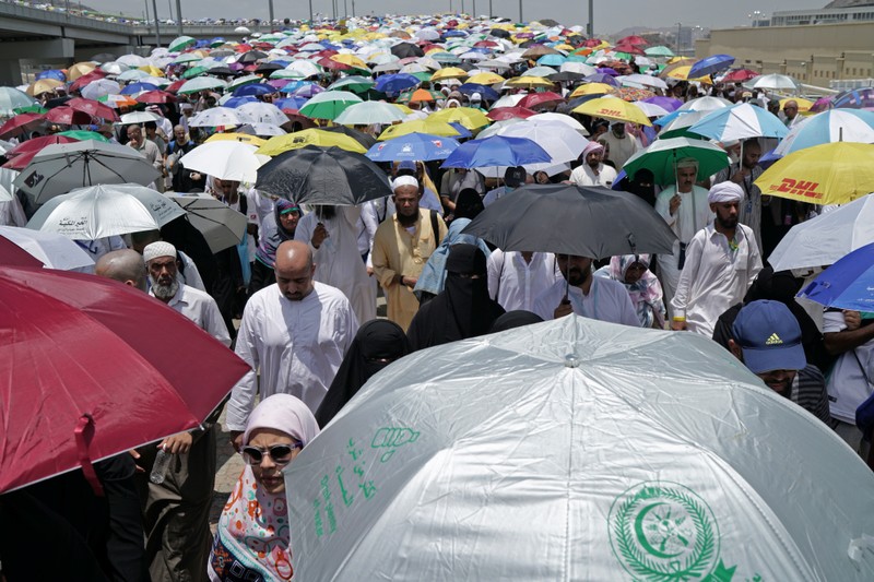 Muslim pilgrims walk to cast their stones at a pillar symbolising the stoning of Satan during the annual haj pilgrimage in Mina