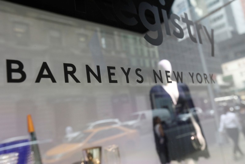 The Barneys New York sign is seen in a display window outside the luxury department store in New York