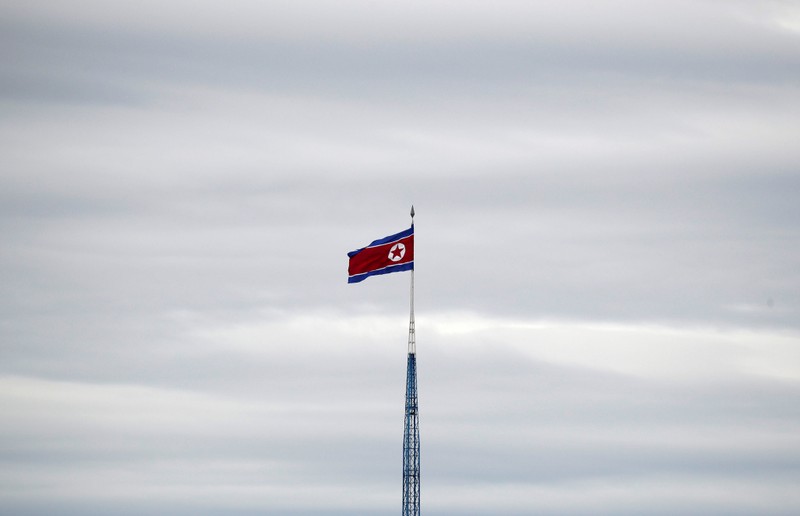 FILE PHOTO: A North Korean flag flutters on top of a 160-metre tower in North Korea's propaganda village of Gijungdong, in this picture taken from the Tae Sung freedom village near the Military Demarcation Line (MDL), in Paju