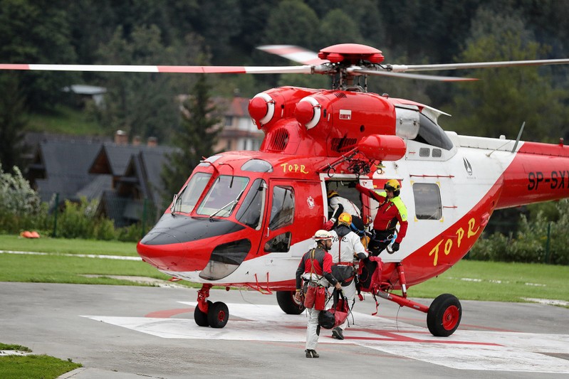 Mountain rescue team (TOPR) members board a helicopter in Zakopane