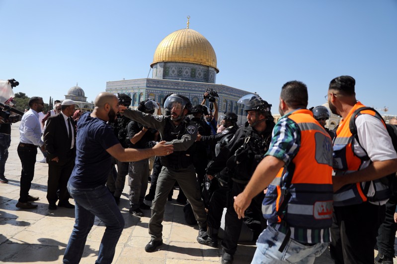 The Dome of the Rock is seen in the background as Israeli police clash with Palestinian worshippers on the compound known to Muslims as Noble Sanctuary and to Jews as Temple Mount as Muslims mark Eid al-Adha, in Jerusalem's Old City