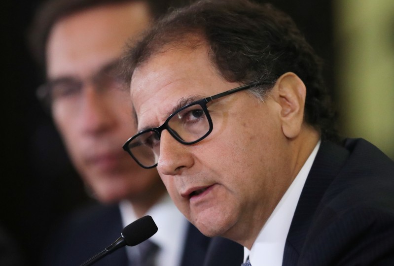 Peru's Energy and Mines Minister Francisco Ismodes next to Peru's President Martin Vizcarra speaks to foreign media during a news conference at the Government Palace in Lima