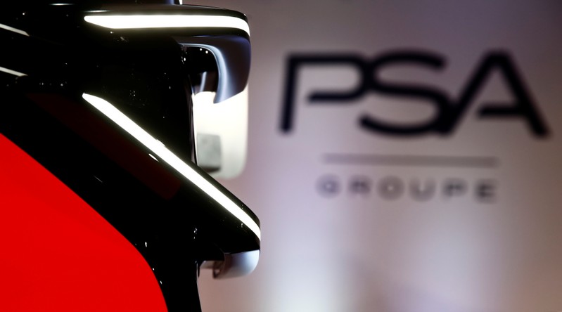 A PSA Group logo is seen behind a car displayed during French carmaker's news conference as they announce the company's 2018 results at their headquarters in Rueil-Malmaison