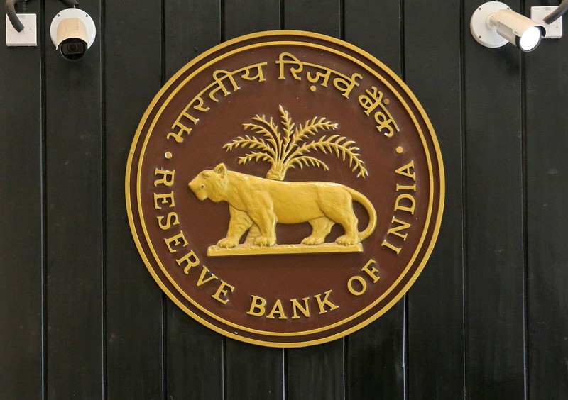 FILE PHOTO: CCTV cameras are seen installed above the logo of Reserve Bank of India (RBI) inside its headquarters in Mumbai