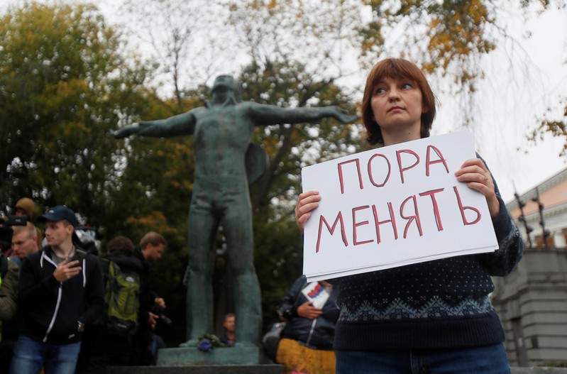 A woman takes part in a protest demanding authorities to allow opposition candidates to run in the upcoming local election and release people arrested for participation in opposition rallies, in Moscow