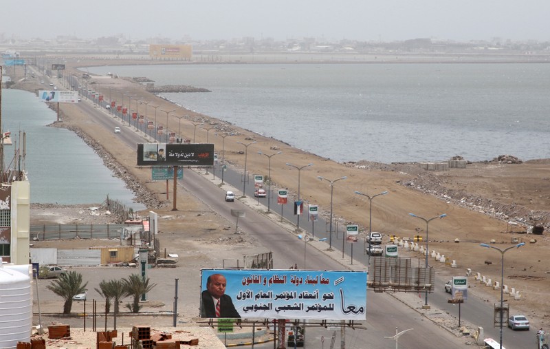 FILE PHOTO: Cars drive on a road linking two neighborhoods of Aden, Yemen
