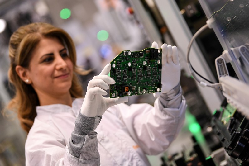 FILE PHOTO: Employee of German car parts maker Continental assembles a power electronics component at the factory of the company's Powertrain unit in Nuremberg