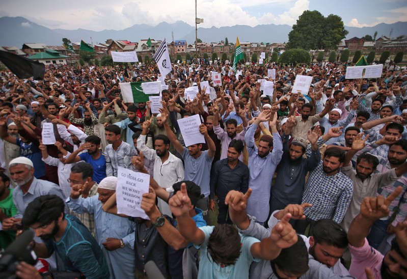 Kashmiris hold placards as they shout slogans at a protest in Srinagar