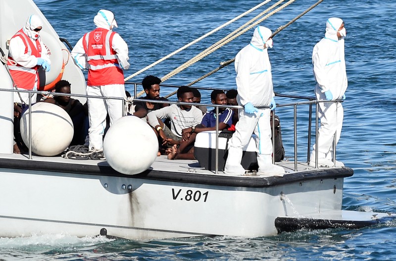 Migrants who were on the Spanish migrant rescue ship Open Arms disembark in Lampedusa