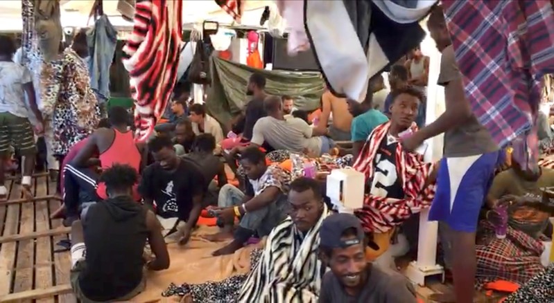 A still image taken from a video shows migrants on board the Spanish rescue ship Open Arms