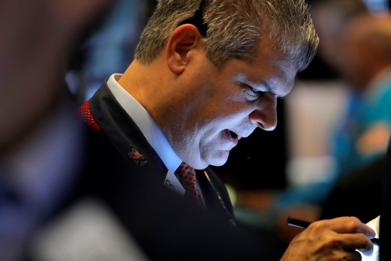 A trader works on the trading floor at the New York Stock Exchange (NYSE) at the opening of the market in New York City